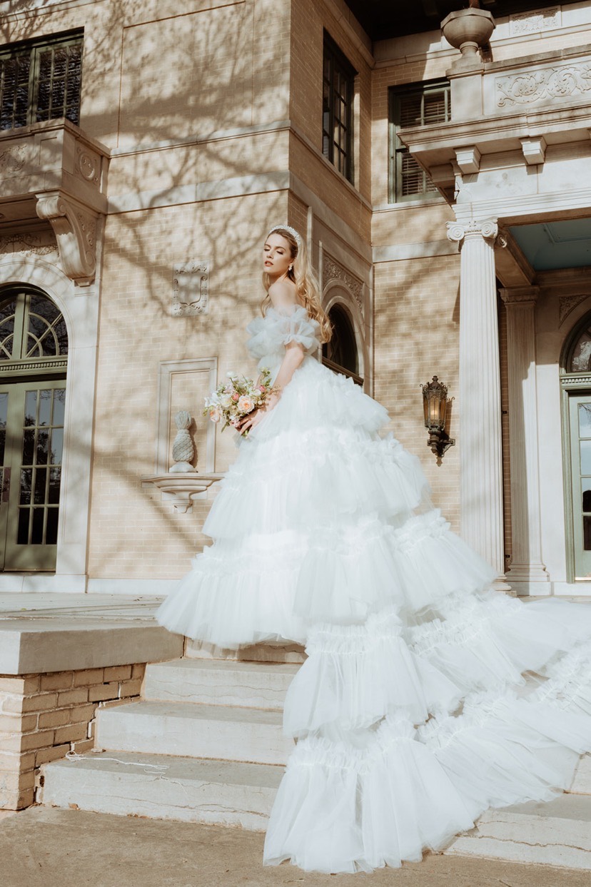 A ruffle tulle ballgown photographed on mansion steps